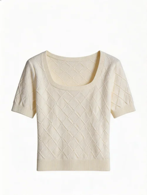 Cream cable-knit top photographed flat