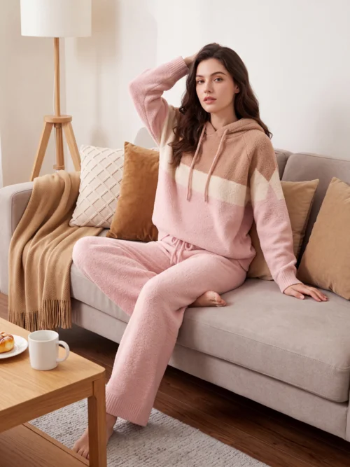 The same cardigan in a virtual try-on shot — an AI model curled up in a beige armchair